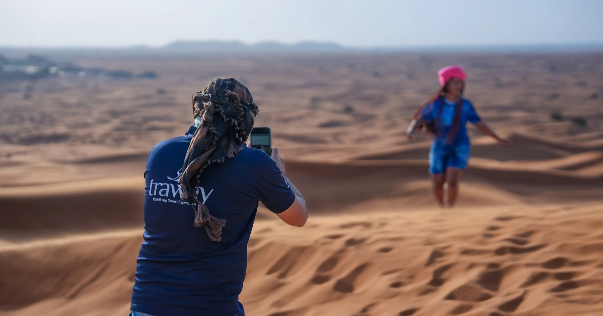 Trawey private guide taking photos for a guest during a personalized private desert safari in Dubai.
