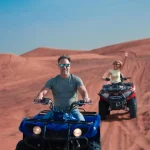Quad biking adventure in Dubai desert dunes; consider safety tips for back pain relief.